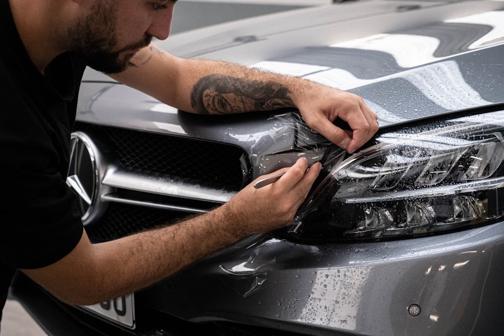 Certified mechanic performing mobile auto repairs on a vehicle